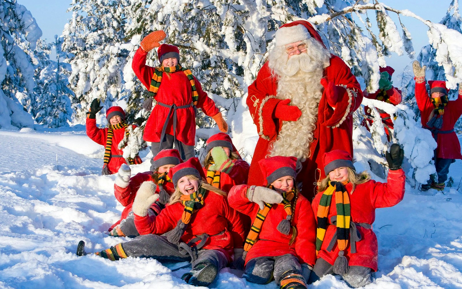 Children with Santa Claus in snowy Santa Claus Village, Rovaniemi.