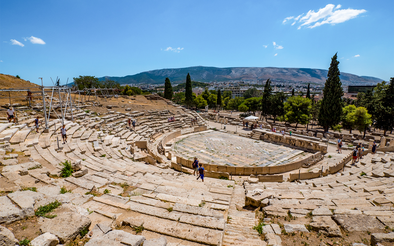 Theatre of Dionysus ruins with visitors, Acropolis, Athens, Greece.