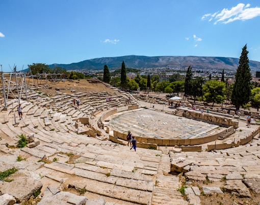 Theatre of Dionysus ruins with visitors, Acropolis, Athens, Greece.