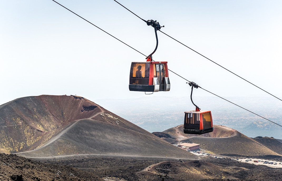 Mount Etna cable car ascending with volcanic crater visible in the background, Sicily.
