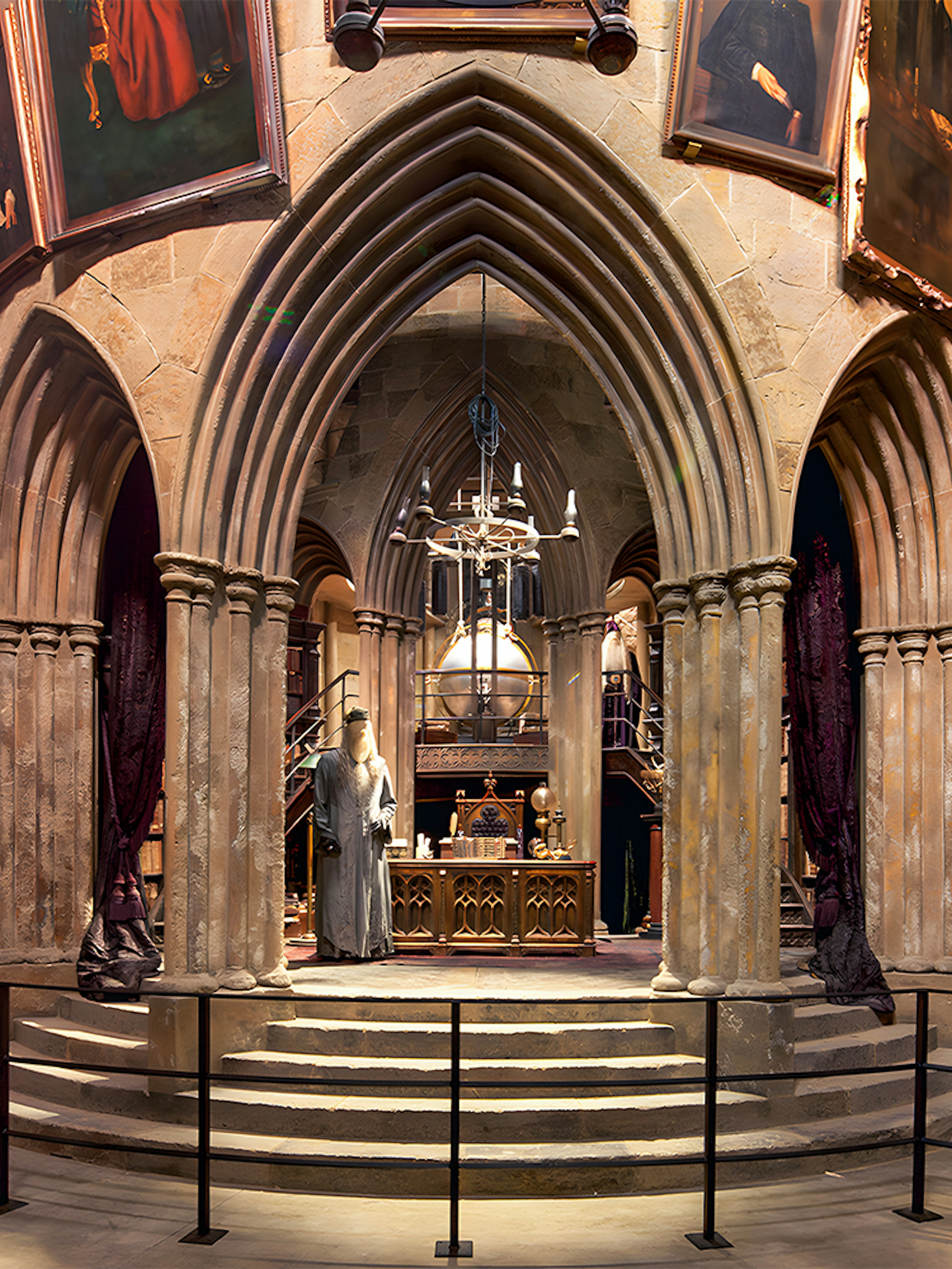 Costume exhibits in a hall at the Harry Potter London tour, featuring Dumbledore's office.