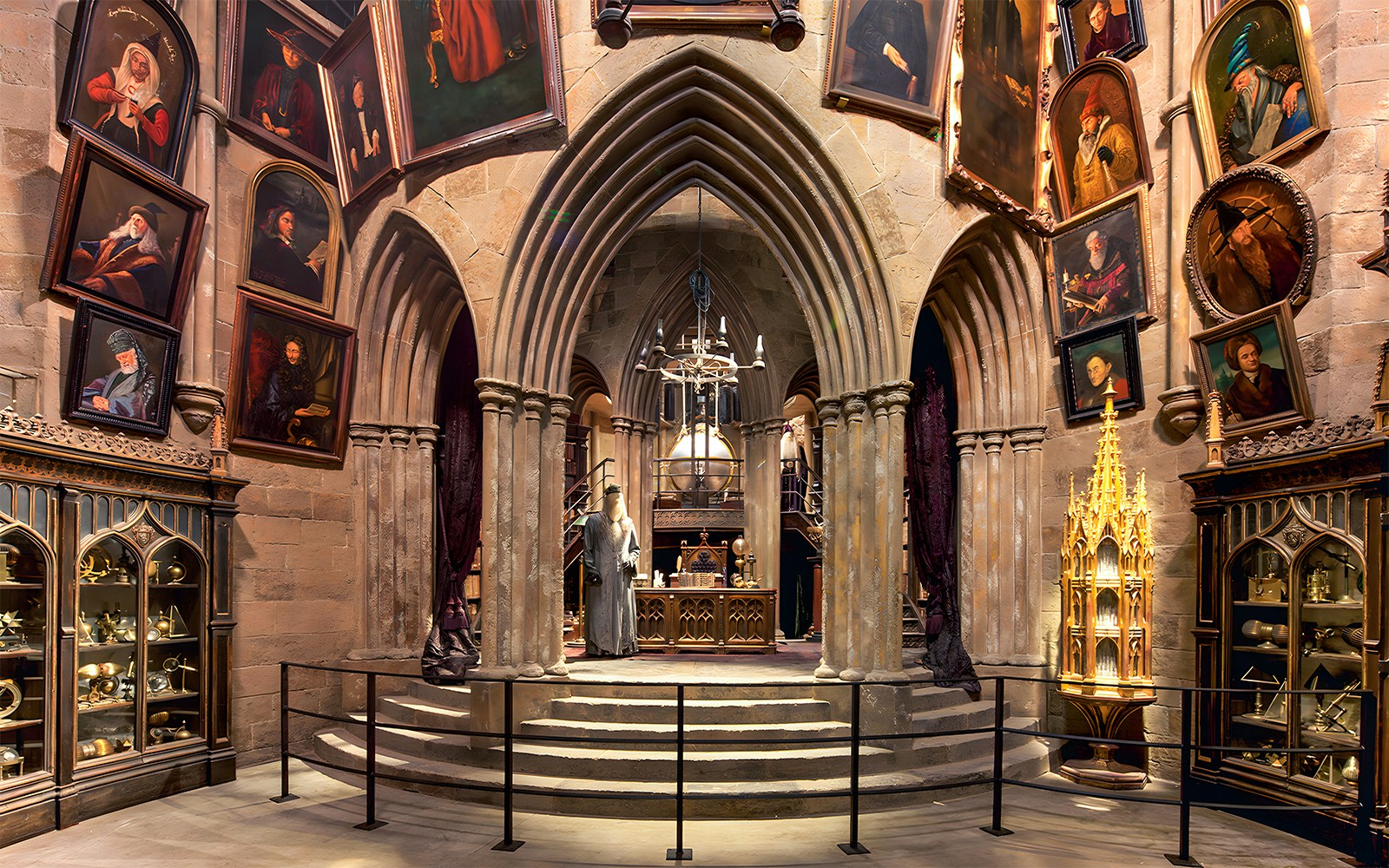 Costume exhibits in a hall at the Harry Potter London tour, featuring Dumbledore's office.