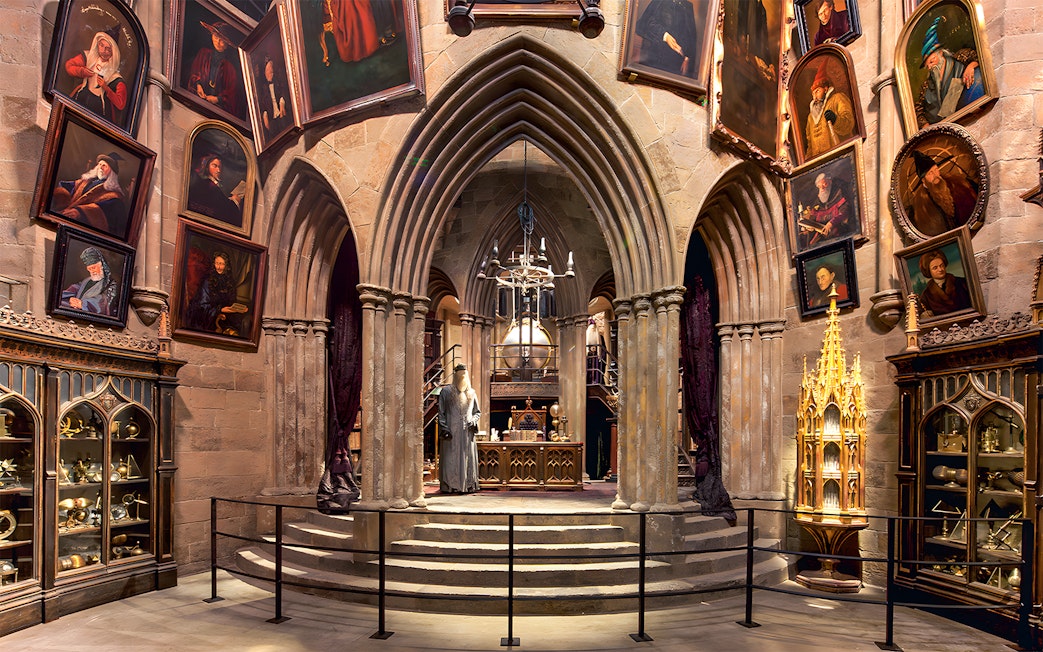 Costume exhibits in a hall at the Harry Potter London tour, featuring Dumbledore's office.