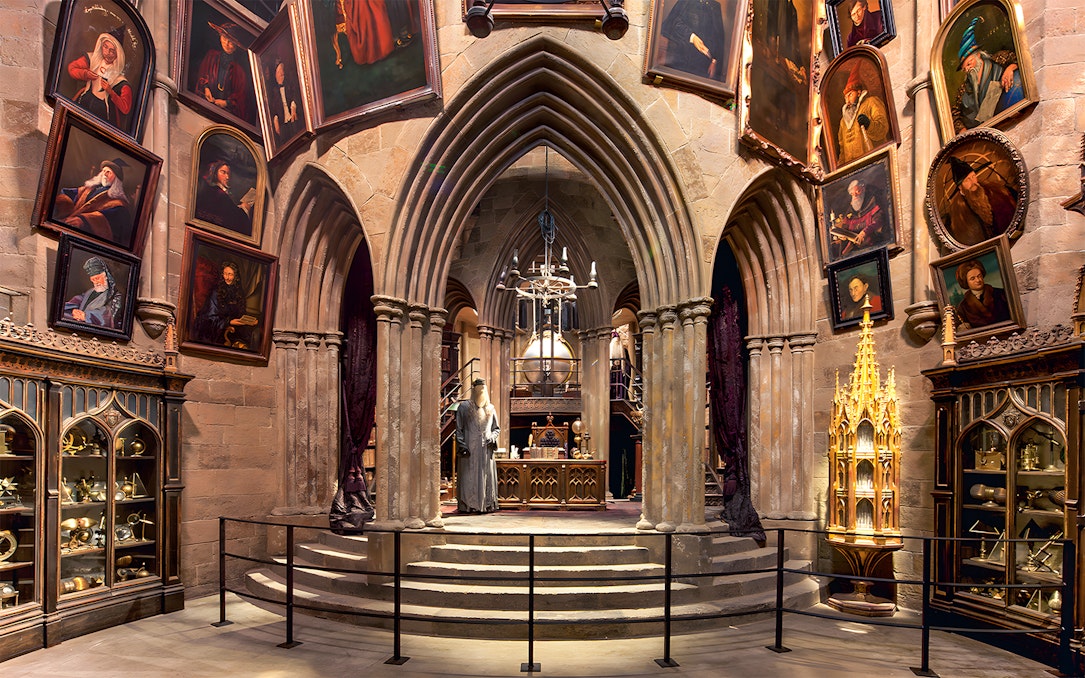 Costume exhibits in a hall at the Harry Potter London tour, featuring Dumbledore's office.
