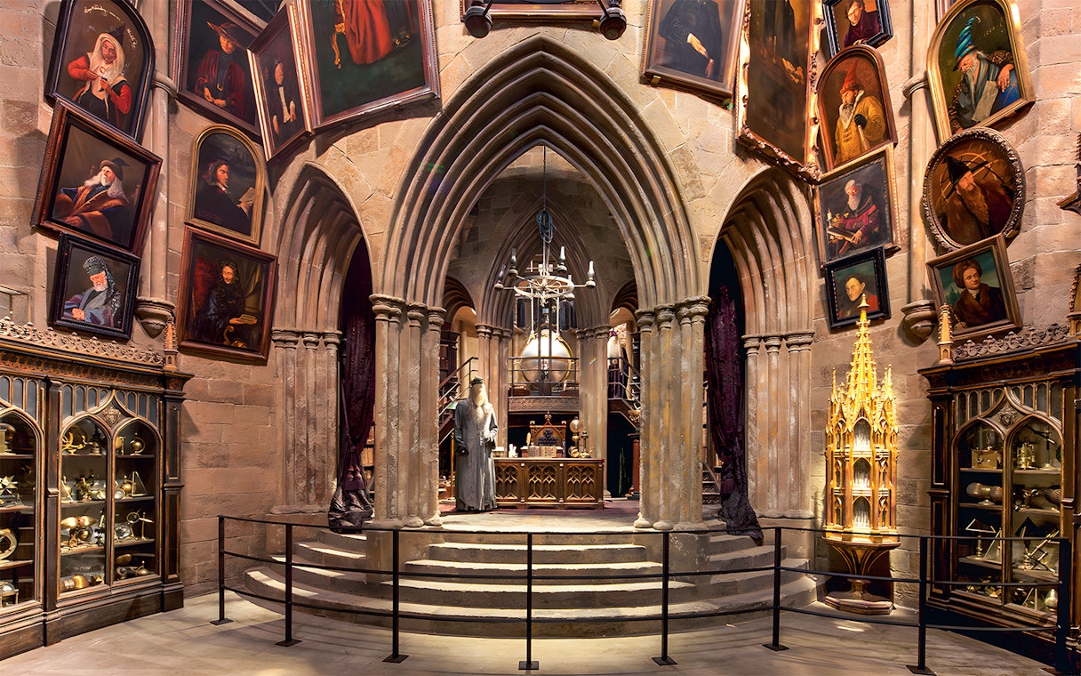 Costume exhibits in a hall at the Harry Potter London tour, featuring Dumbledore's office.