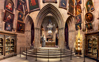 Costume exhibits in a hall at the Harry Potter London tour, featuring Dumbledore's office.