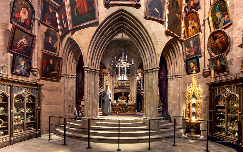 Costume exhibits in a hall at the Harry Potter London tour, featuring Dumbledore's office.
