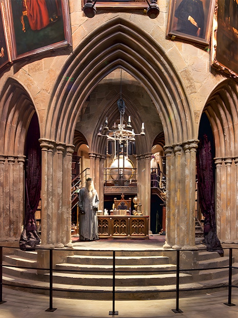 Costume exhibits in a hall at the Harry Potter London tour, featuring Dumbledore's office.