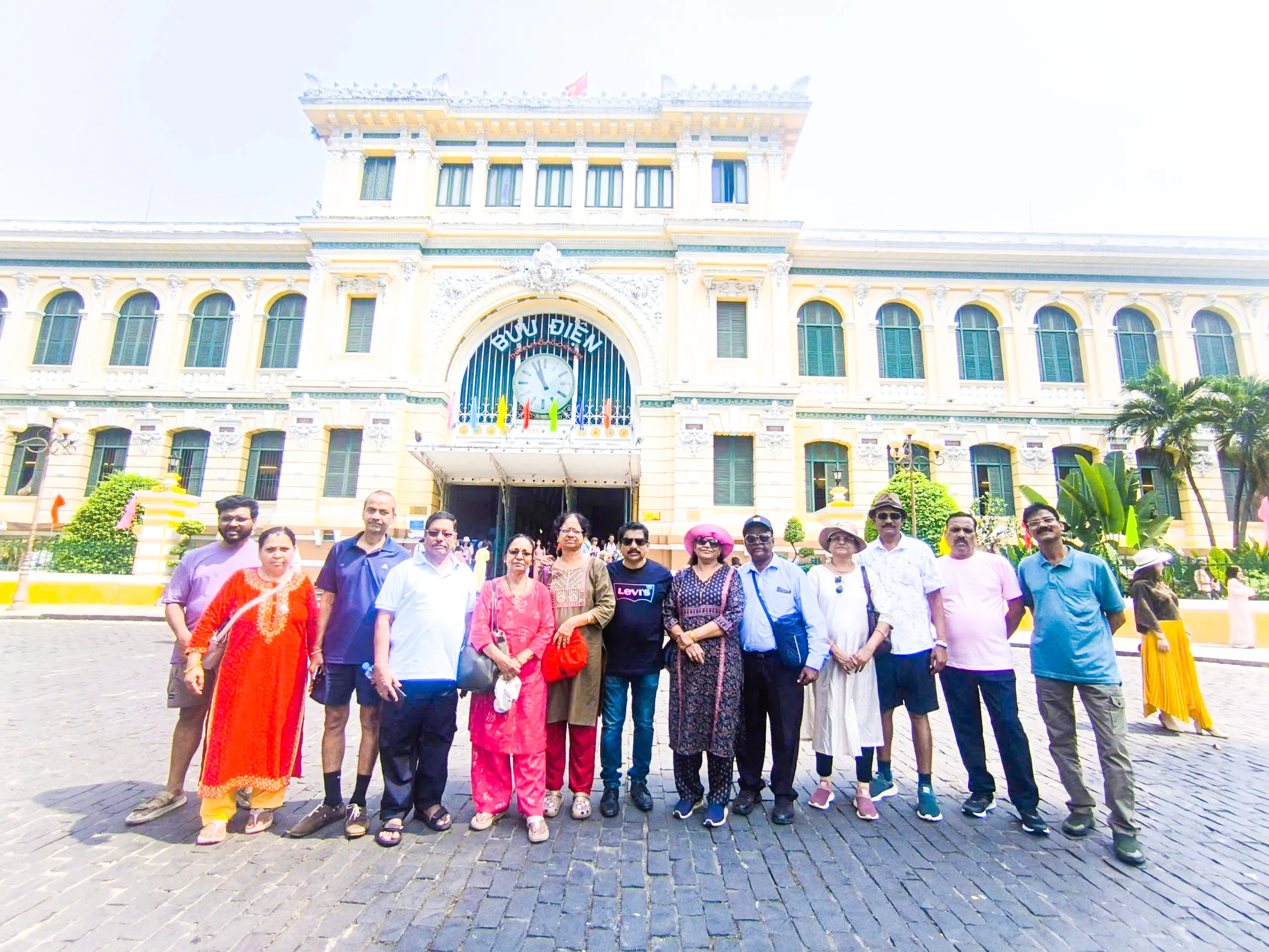 Group of tourists in front of the historic Central Post Office, Ho Chi Minh City.