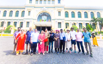 Group of tourists in front of the historic Central Post Office, Ho Chi Minh City.