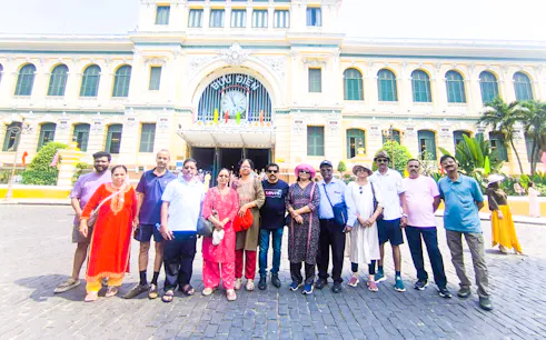 Group of tourists in front of the historic Central Post Office, Ho Chi Minh City.