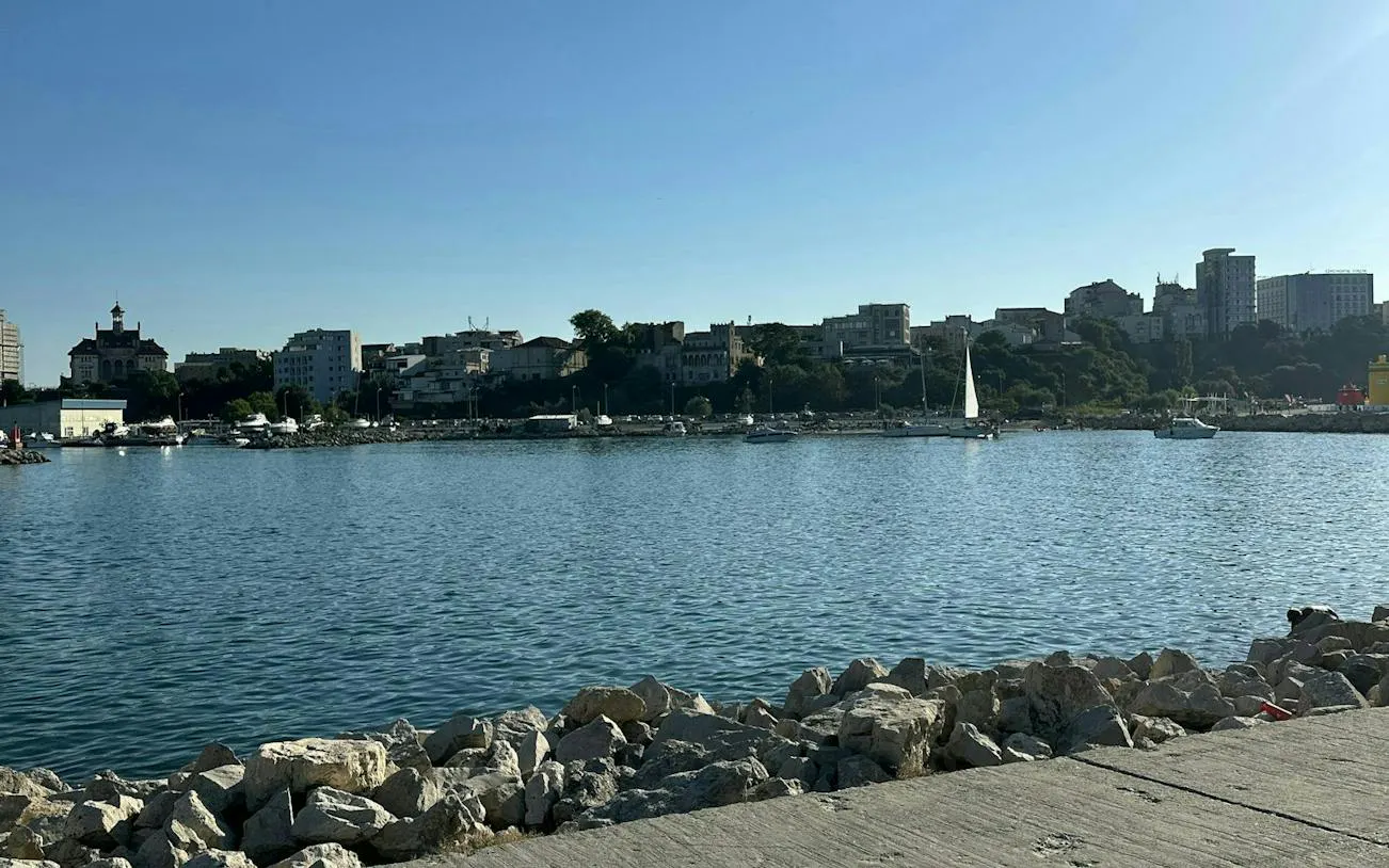 Constanta waterfront with boats and city skyline, part of the Haunted Constanta Black Sea Monster tour.