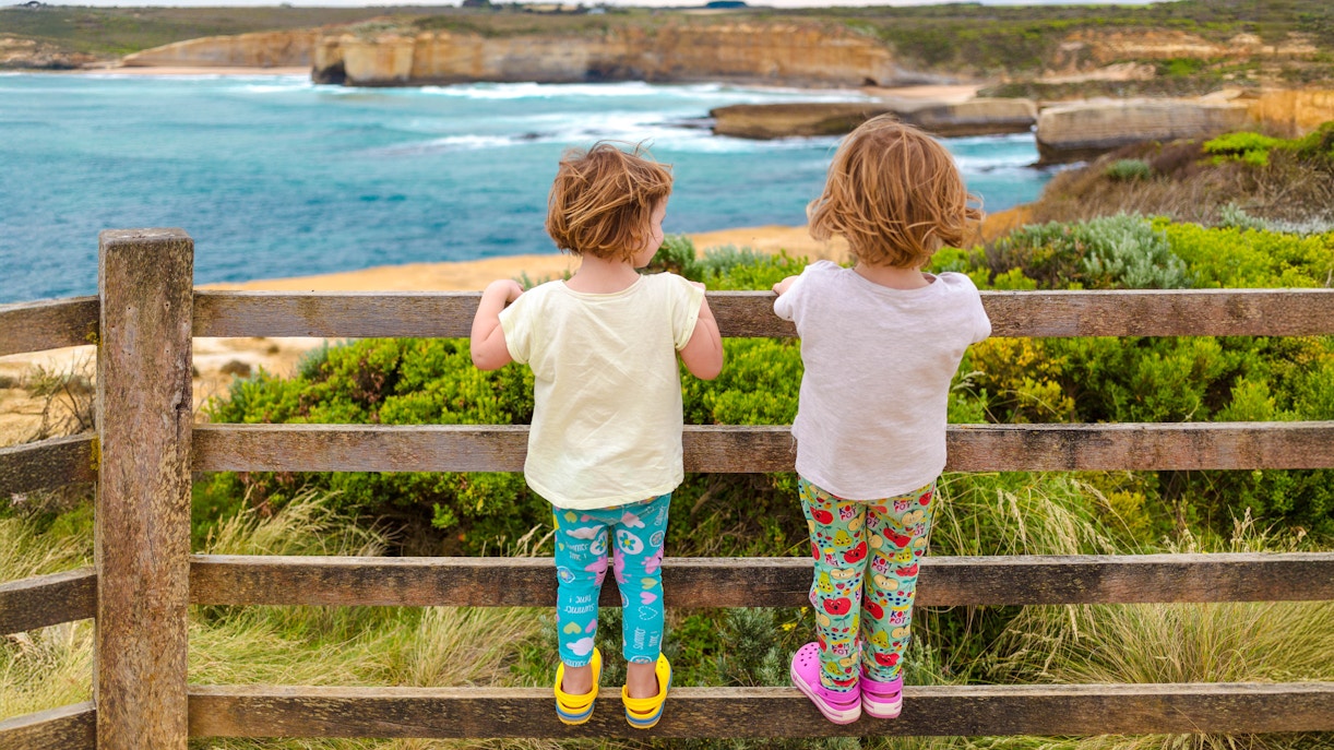 Children enjoying a scenic view along the Great Ocean Road, Australia.