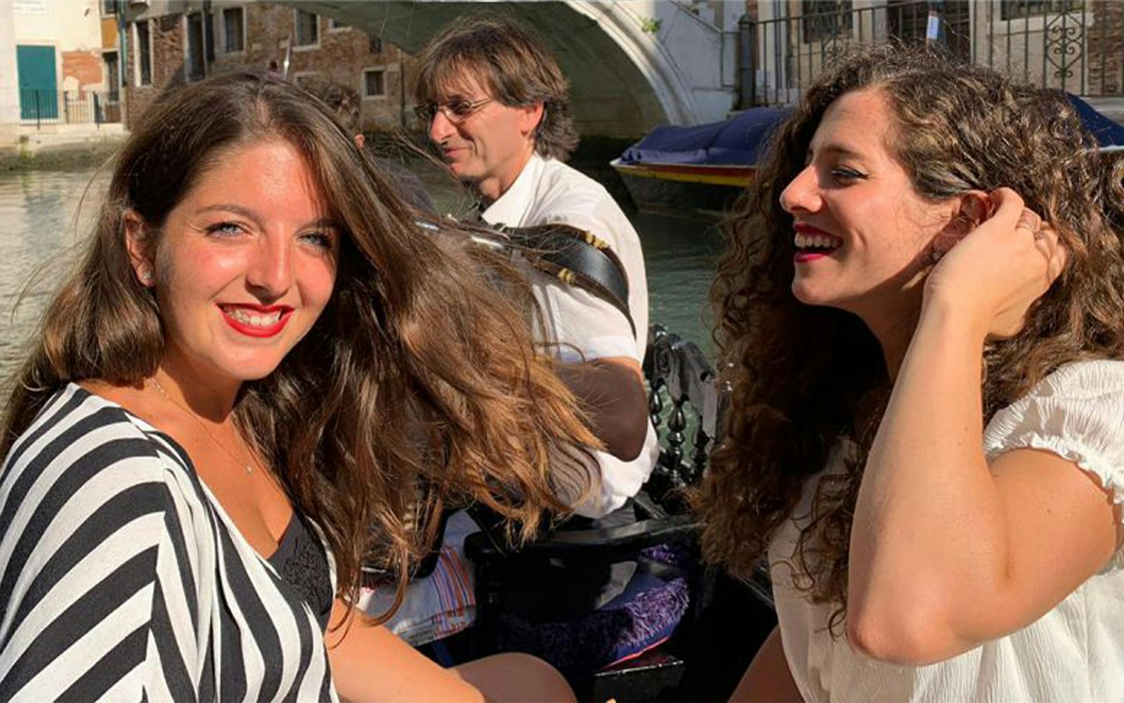 Gondolier serenading passengers on a Venice canal.