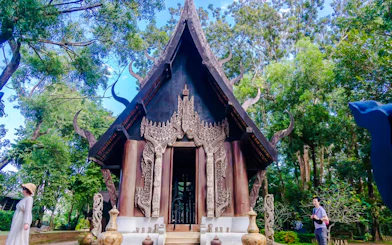 Close-up of ornate Black House (Baan Dam) entrance in Chiang Rai, Thailand.