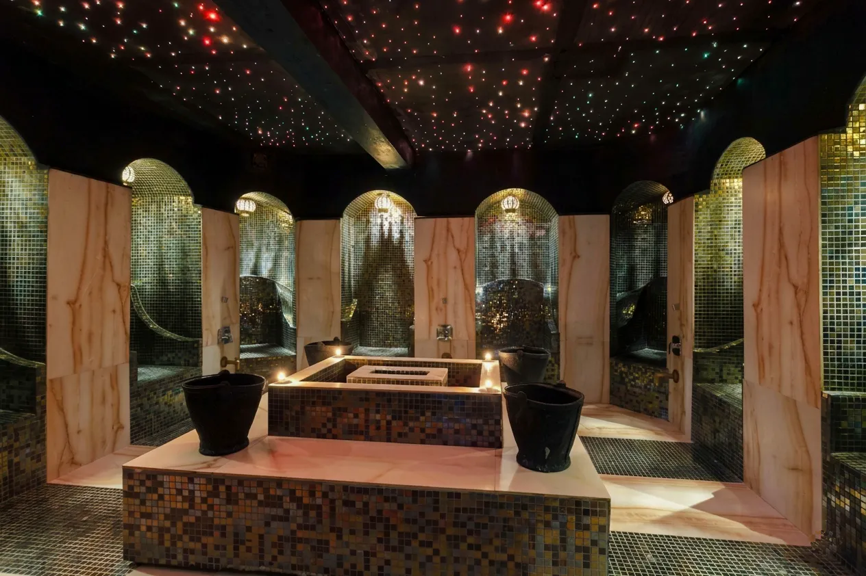 Luxurious Moroccan hammam interior with mosaic tiles and ambient lighting in Marrakech.