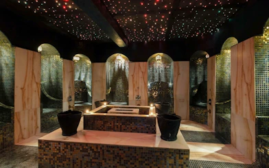Luxurious Moroccan hammam interior with mosaic tiles and ambient lighting in Marrakech.