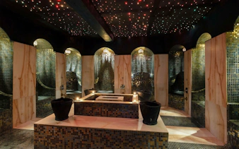 Luxurious Moroccan hammam interior with mosaic tiles and ambient lighting in Marrakech.