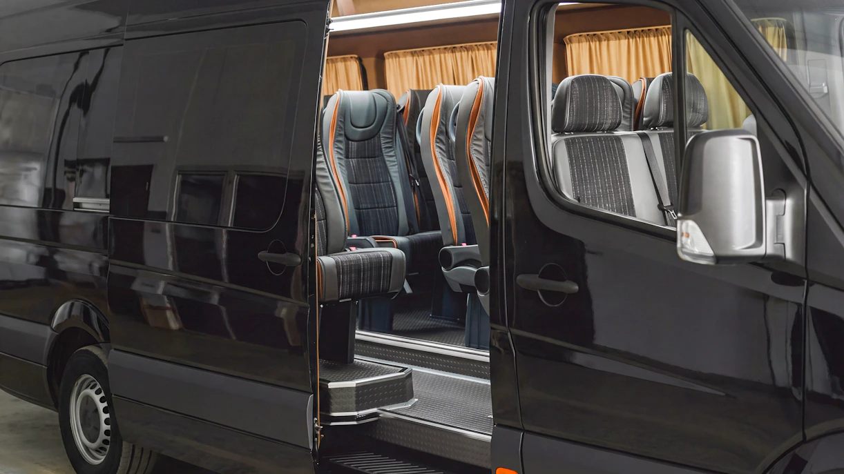 Mercedes mini van with open door showing interior seating for transfers.