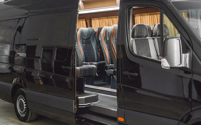 Mercedes mini van with open door showing interior seating for transfers.