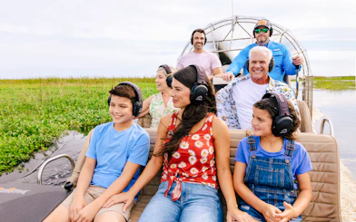 Guests listening to guide during Everglades Airboat Tour.