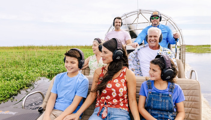 Guests listening to guide on Everglades airboat tour, Florida.