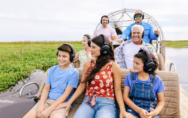 Guests listening to guide during Everglades Airboat Tour.
