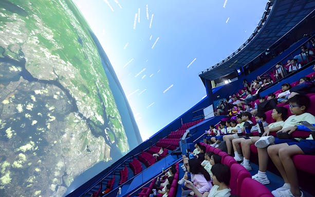 Visitors watching a planetarium show at Omni Theatre, Singapore.
