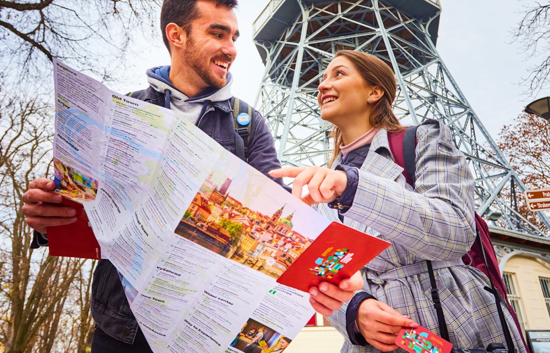 Tourists with map near Petřín Lookout Tower, Prague, using 48/72/120 Hours Visitor Pass.