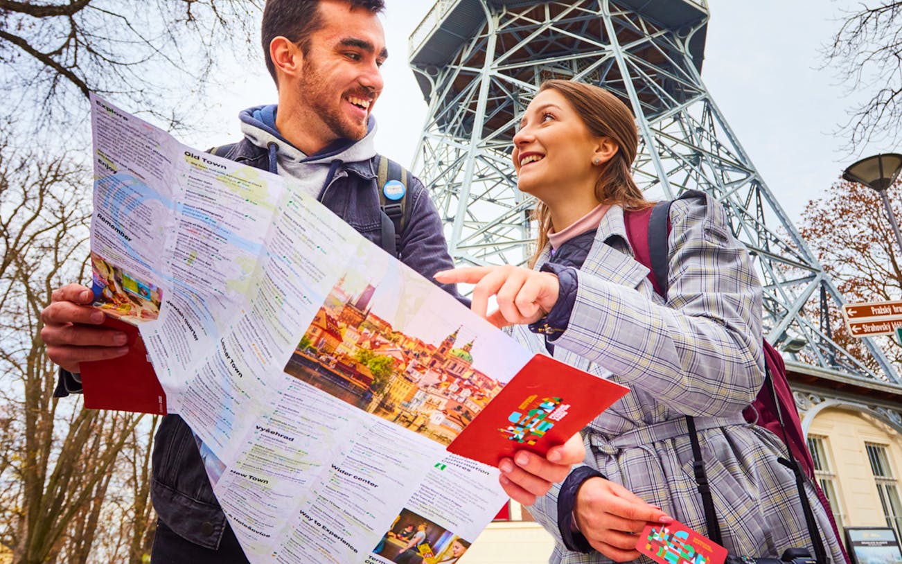 Tourists with map near Petřín Lookout Tower, Prague, using 48/72/120 Hours Visitor Pass.