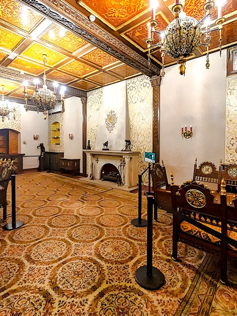 Ceaușescu Mansion interior with ornate wooden furniture and decorative ceiling, Bucharest.