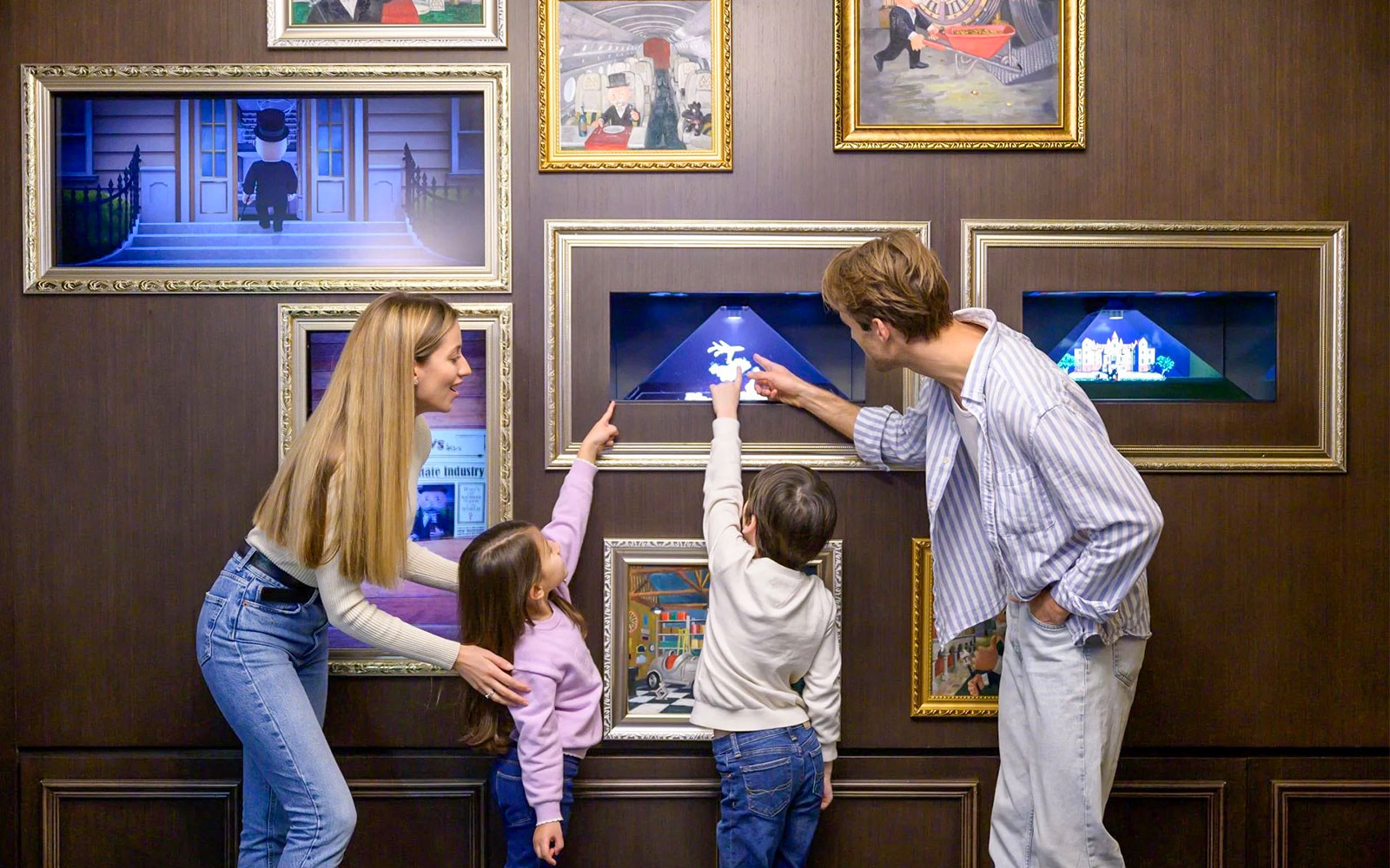 Family looking at frames in Monopoly Dreams Melbourne
