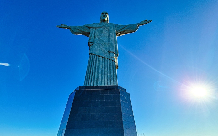Christ the Redeemer statue under clear blue sky in Rio de Janeiro, Brazil.