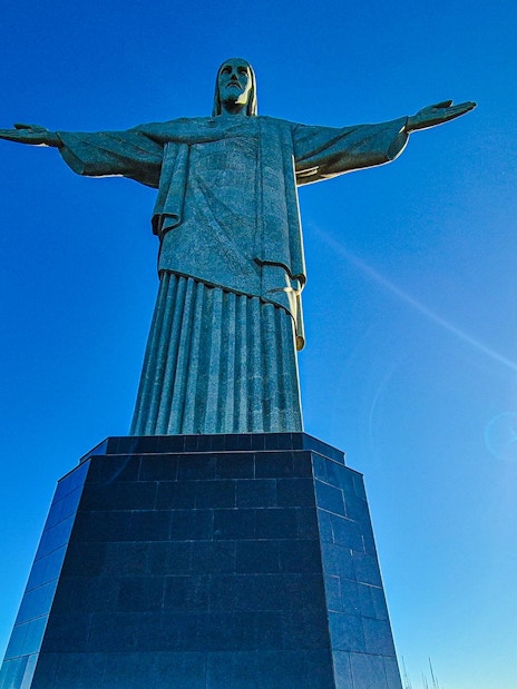 Christ the Redeemer statue under clear blue sky in Rio de Janeiro, Brazil.
