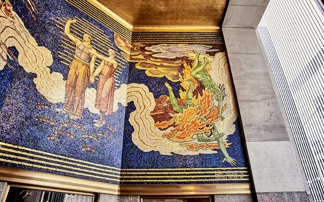 Mosaic mural at Rockefeller Center depicting figures and abstract designs.