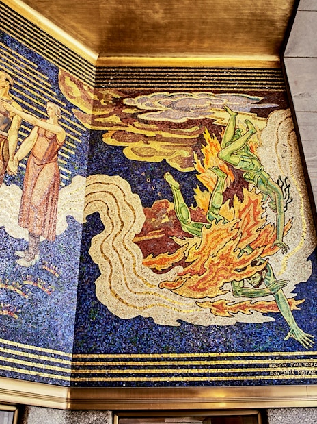 Mosaic mural at Rockefeller Center depicting figures and abstract designs.