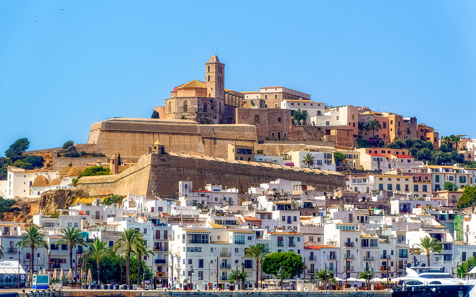 A sea side view to the Ibiza Old Town with Cathedral of Santa Maria d`Eivissa at the top of the hill in Ibiza, Spain.