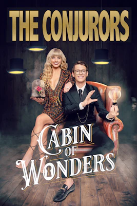 Magician performing card trick at The Conjurors show in London theater.