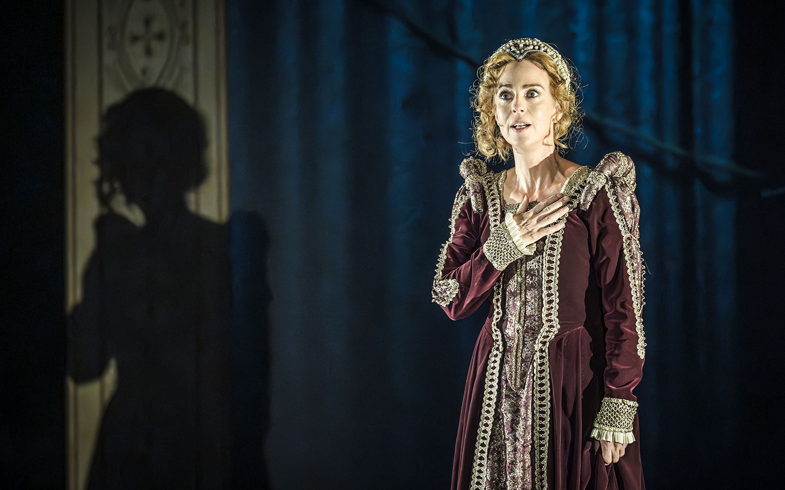Performer in period costume on stage in Grace Pervades West End show.