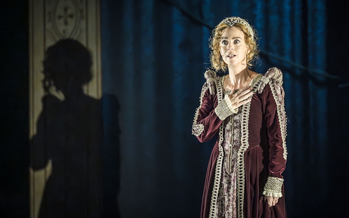 Performer in period costume on stage in Grace Pervades West End show.