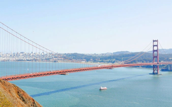 Golden Gate Bridge with cruise boat in San Francisco Bay.