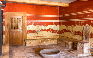 King's chamber of Knossos with frescoes and stone throne, Crete, Greece.
