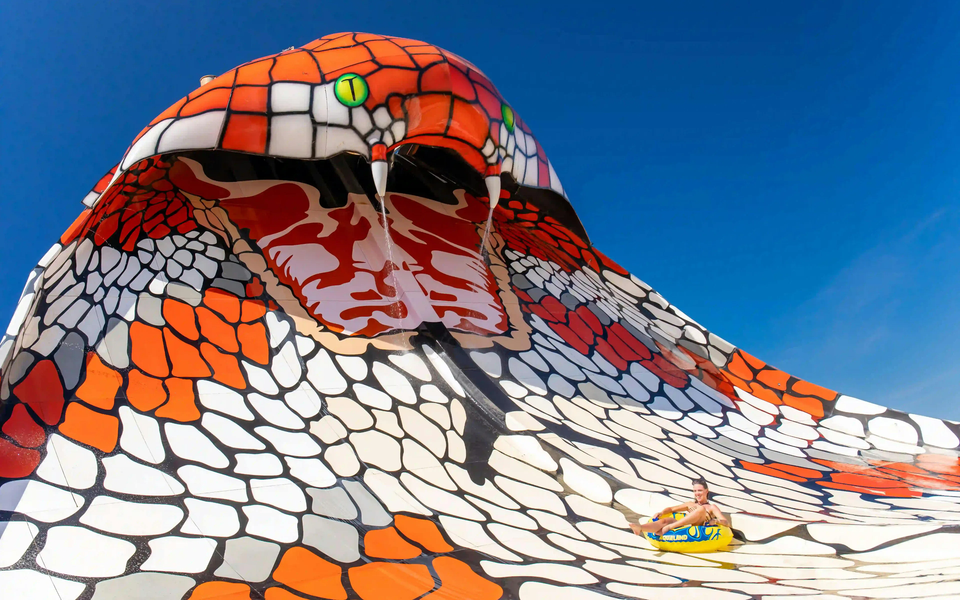 Visitors sliding on King Cobra ride at Aqualand Algarve.