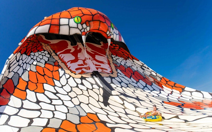 Visitors sliding on King Cobra ride at Aqualand Algarve.