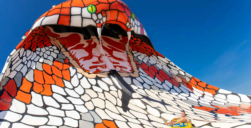 Visitors sliding on King Cobra ride at Aqualand Algarve.