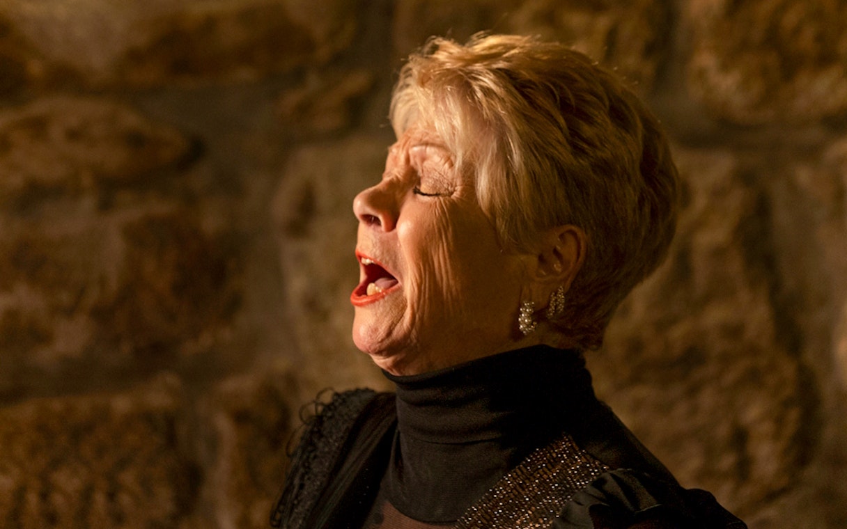 Singer performing at Fado Maior during an intimate Fado show.