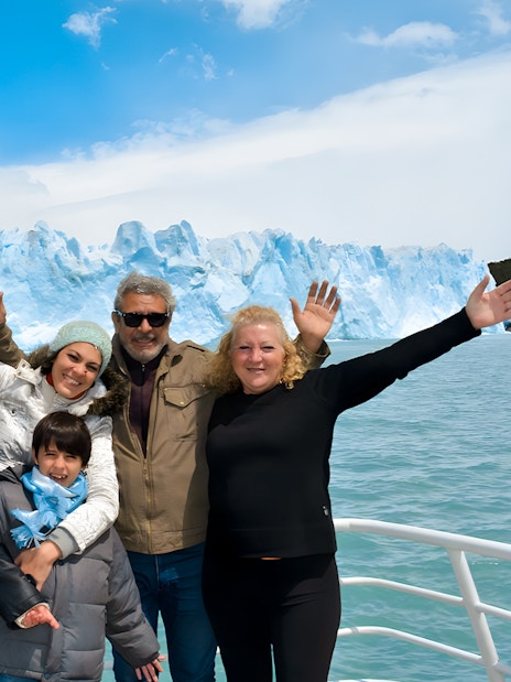 Tourists on cruise posing in front of Perito Moreno Glacier in Argentina.