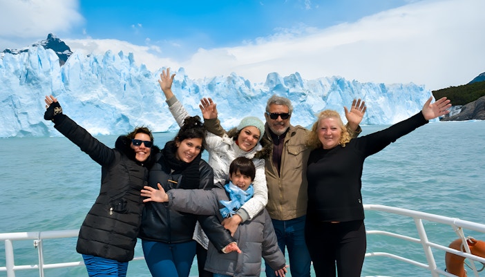 Tourists on cruise posing in front of Perito Moreno Glacier in Argentina.