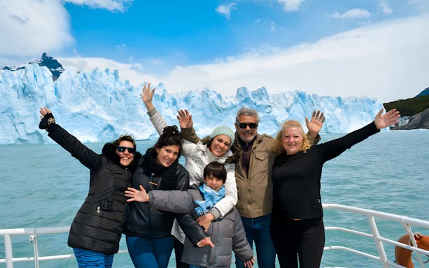 Tourists on cruise posing in front of Perito Moreno Glacier in Argentina.