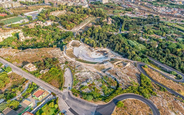 Aerial view of the ancient Greek theater in Neapolis Archaeological Park, Syracuse, Italy.